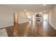 Open-concept living room with hardwood floors, fireplace, and neutral color palette at 4720 W Tradwell Dr, New Palestine, IN 46163