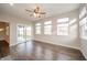 Living room with hardwood floors, slider to the backyard, and neutral walls at 4720 W Tradwell Dr, New Palestine, IN 46163