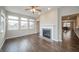 Bright living room featuring hardwood floors, a fireplace, and several windows at 4720 W Tradwell Dr, New Palestine, IN 46163