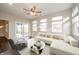 Bright living room with hardwood floors, slider to the backyard, and modern decor at 4720 W Tradwell Dr, New Palestine, IN 46163