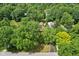 An aerial shot reveals a residence nestled among trees, showcasing the home's seclusion and landscape at 4754 E 64Th St, Indianapolis, IN 46220
