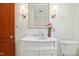 Bathroom with white vanity, modern lighting and fixtures, and a wood door at 4754 E 64Th St, Indianapolis, IN 46220