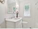 Bathroom features a white vanity, modern fixtures, and a window providing natural light at 4754 E 64Th St, Indianapolis, IN 46220