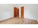 A bedroom featuring multiple doors and wood-look floors at 4754 E 64Th St, Indianapolis, IN 46220