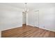 A bedroom with wood-look floors, white walls, closet, and neutral decor at 4754 E 64Th St, Indianapolis, IN 46220