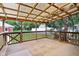 Covered outdoor deck overlooking fenced backyard with basketball goal and greenery at 4754 E 64Th St, Indianapolis, IN 46220