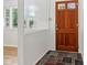 Welcoming entryway featuring a wood door and beautiful stone flooring, bathed in natural light at 4754 E 64Th St, Indianapolis, IN 46220