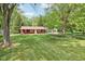 Charming single-story home with large, manicured lawn and mature trees at 4754 E 64Th St, Indianapolis, IN 46220