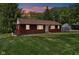 Cozy home with a well-maintained lawn and manicured landscaping, under a beautiful evening sky at 4754 E 64Th St, Indianapolis, IN 46220