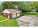 Two-car garage with a red roof, white doors, and a basketball hoop on a concrete pad at 4754 E 64Th St, Indianapolis, IN 46220
