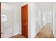 Hallway with hardwood floors and white walls, next to bathroom with white hexagon tile at 4754 E 64Th St, Indianapolis, IN 46220
