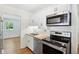 Updated kitchen with white cabinetry, stainless steel appliances, and wood countertops at 4754 E 64Th St, Indianapolis, IN 46220