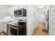 A kitchen features stainless steel appliances, white cabinets, butcher block countertops and a view into the hall at 4754 E 64Th St, Indianapolis, IN 46220