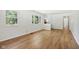 Bright living room with wood floors, white walls, and ample natural light from the large windows at 4754 E 64Th St, Indianapolis, IN 46220