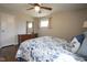 Charming bedroom with hardwood floors, two windows, dresser, and ceiling fan at 5415 Wallace Ave, Indianapolis, IN 46220
