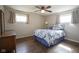 Comfortable bedroom featuring hardwood floors, two windows, and a ceiling fan at 5415 Wallace Ave, Indianapolis, IN 46220