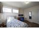 Cozy bedroom features hardwood floors, desk, and two large windows at 5415 Wallace Ave, Indianapolis, IN 46220