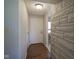 Inviting entryway features hardwood floors, a white front door, and stone accent wall at 5415 Wallace Ave, Indianapolis, IN 46220