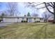 Ranch-style home with attached garage, manicured shrubs, and a well-kept front lawn at 5415 Wallace Ave, Indianapolis, IN 46220