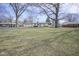 Single-story home with a large front yard, mature trees, and classic design at 5415 Wallace Ave, Indianapolis, IN 46220