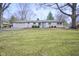 Charming ranch-style home featuring a manicured lawn, attached garage and eye-catching light blue front door at 5415 Wallace Ave, Indianapolis, IN 46220
