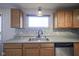 Kitchen featuring a stainless steel sink, neutral countertops, and wood cabinets at 5415 Wallace Ave, Indianapolis, IN 46220