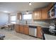 Functional kitchen featuring stainless steel appliances, light wood cabinets, and neutral countertops at 5415 Wallace Ave, Indianapolis, IN 46220