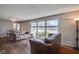 Comfortable living room with hardwood floors, neutral paint, and large window offering views of the backyard at 5415 Wallace Ave, Indianapolis, IN 46220