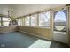 Enclosed porch with backyard views, string lights, a screen door, and green flooring at 5415 Wallace Ave, Indianapolis, IN 46220