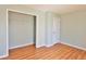 Bedroom featuring wood-look floors, closet, and light green walls at 5944 Edelle Dr, Indianapolis, IN 46237