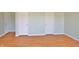 A bedroom with wood-look floors has a pale green paint with two doors visible at 5944 Edelle Dr, Indianapolis, IN 46237