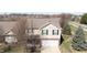 Two-story home with light beige siding, black shutters, and a brick front, plus an attached garage at 5944 Edelle Dr, Indianapolis, IN 46237