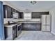 This kitchen features dark cabinets, stainless steel appliances, and a window over the sink at 5944 Edelle Dr, Indianapolis, IN 46237