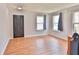 Inviting living room with light gray walls, laminate flooring, and natural light from multiple windows at 5944 Edelle Dr, Indianapolis, IN 46237