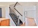 Interior shot of a staircase with black banister and wood steps, connecting the home's multiple levels at 5944 Edelle Dr, Indianapolis, IN 46237