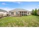 The home features a screened in porch and concrete patio with chairs in a well-maintained backyard at 7236 Sunset Point Dr, Indianapolis, IN 46259