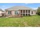The home features a screened in porch and concrete patio with chairs in a well-maintained backyard at 7236 Sunset Point Dr, Indianapolis, IN 46259