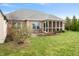 The home features a screened in porch and concrete patio with chairs in a well-maintained backyard at 7236 Sunset Point Dr, Indianapolis, IN 46259