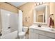 Well-lit bathroom featuring a shower-tub combo, toilet, and vanity with storage, all in a clean, neutral color palette at 7236 Sunset Point Dr, Indianapolis, IN 46259