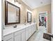 Spacious bathroom with double sink vanity, ample lighting, and a doorway leading to a walk-in closet at 7236 Sunset Point Dr, Indianapolis, IN 46259