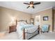 Comfortable bedroom with neutral walls, carpet, ceiling fan, and furniture, with an open doorway to an adjoining bathroom at 7236 Sunset Point Dr, Indianapolis, IN 46259