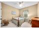 Charming bedroom featuring neutral walls, carpet, a ceiling fan, with two rocking chairs at 7236 Sunset Point Dr, Indianapolis, IN 46259