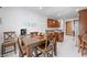 Cozy dining area with wooden table, chairs, and a view into the kitchen at 7236 Sunset Point Dr, Indianapolis, IN 46259