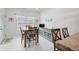 Bright dining area with a wooden table and chairs, a decorative buffet, and a window at 7236 Sunset Point Dr, Indianapolis, IN 46259