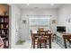 Dining area with wooden table and chairs, a window, and decorative accents at 7236 Sunset Point Dr, Indianapolis, IN 46259