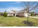 Brick home with a two-car garage and manicured lawn, set in a peaceful neighborhood at 7236 Sunset Point Dr, Indianapolis, IN 46259