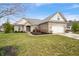 Exterior shot of brick home with two car garage, manicured lawn, and mulched garden at 7236 Sunset Point Dr, Indianapolis, IN 46259