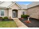 Inviting front entrance with mulched garden and walkway, enhancing the home's curb appeal at 7236 Sunset Point Dr, Indianapolis, IN 46259