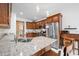Spacious kitchen featuring wood cabinets, stainless appliances, granite countertops, and an eat-in island at 7236 Sunset Point Dr, Indianapolis, IN 46259