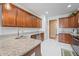 Bright kitchen with granite counters, stainless steel appliances, wooden cabinets and white tile backsplash at 7236 Sunset Point Dr, Indianapolis, IN 46259